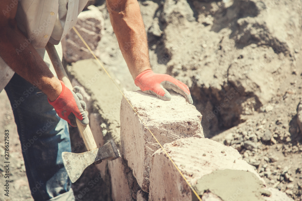 The builder is building a wall The builder is building a wall