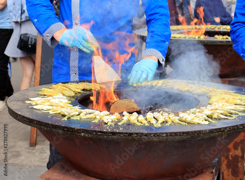 cooking on fire on a city street photo