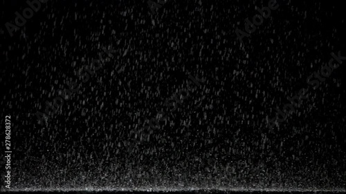 highspeed plate shot isolated rain pouring onto floor against black background