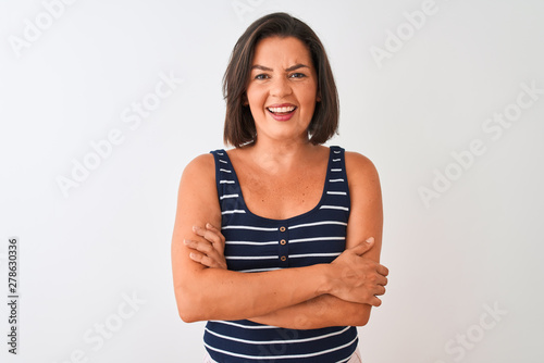 Young beautiful woman wearing blue striped t-shirt standing over isolated white background happy face smiling with crossed arms looking at the camera. Positive person. © Krakenimages.com