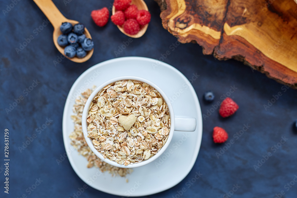 Raspberries and blueberries on blue background. Cereals. Raspberries and blueberries on blue background. Cereals.