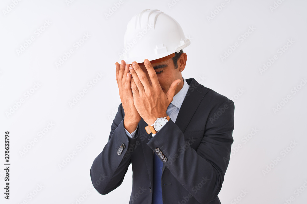 Young handsome architect man wearing suit and helmet over isolated white background with sad expression covering face with hands while crying. Depression concept. Young handsome architect man wearing suit and helmet over isolated white background with sad expression covering face with hands while crying. Depression concept.