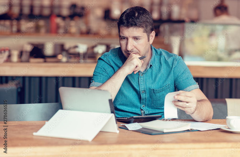 Owner of a Small business checking monthly reports bills and expenses of his Restaurant Owner of a Small business checking monthly reports bills and expenses of his Restaurant