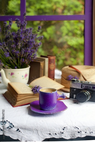 Still life with lavender  coffee in a purple cup  books by the window. Romantic still life with lavender.