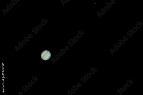 Planet Jupiter as seen from an advanced amateur telescope from a city sky at Santiago de Chile. Jupiter, the Giant Gas Planet show us its belts and spots like the great red spot, an awe night view
