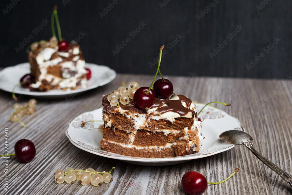 two pieces of chocolate cake with a cherry two pieces of chocolate cake with a cherry