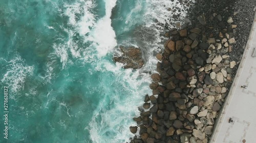 Stone protection for the promenade on the Spanish island of Gran Canaria, Agaete. All the power of nature in the beautiful Atlantic Ocean, crystal clear water of green and turquoise, aerial view
