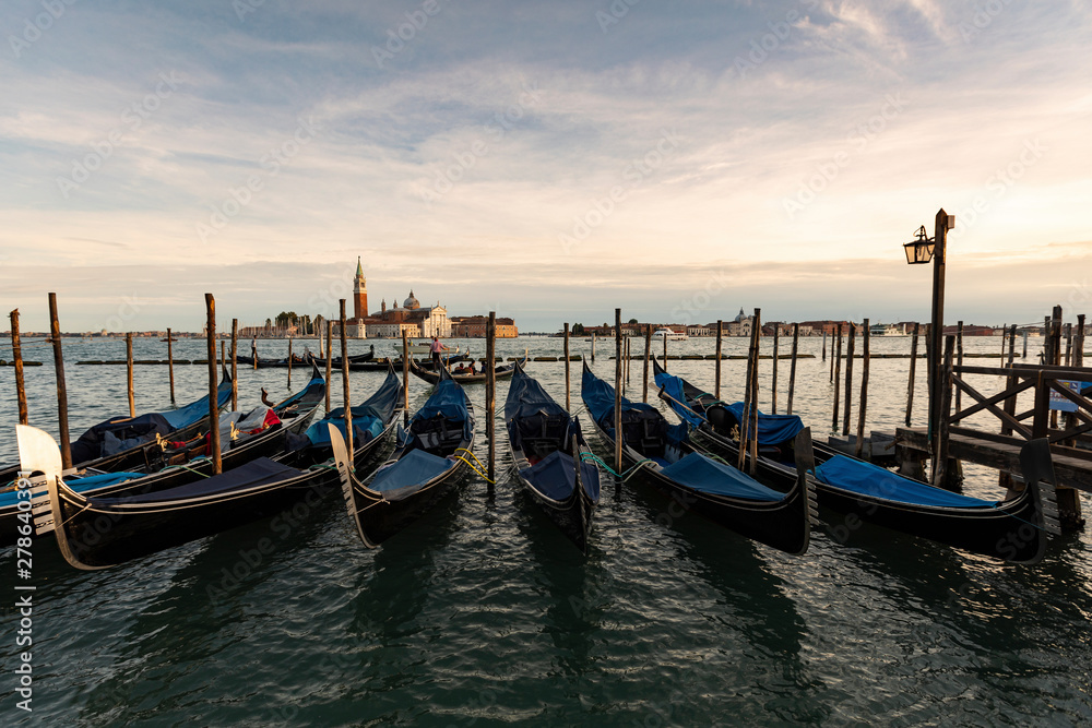 View to San Giorgio Maggiore with row of gondolas in the foreground in the evening, Venice, Italy View to San Giorgio Maggiore with row of gondolas in the foreground in the evening, Venice, Italy