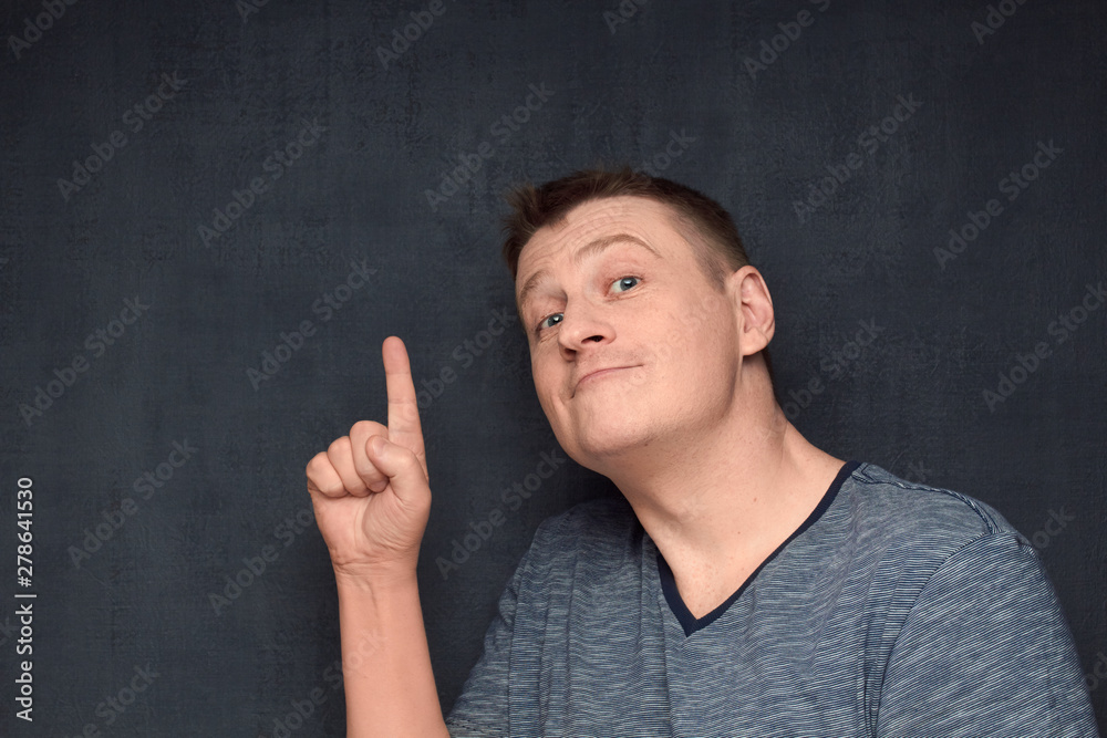 Portrait of funny man pointing up with forefinger Portrait of funny man pointing up with forefinger
