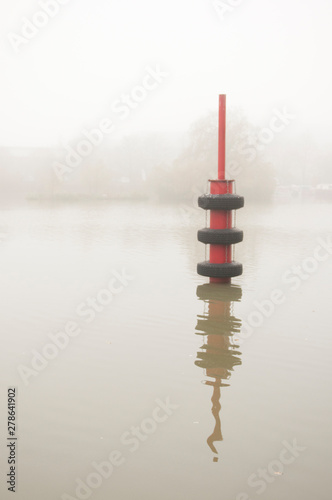  Lake in the fog, pier pole.