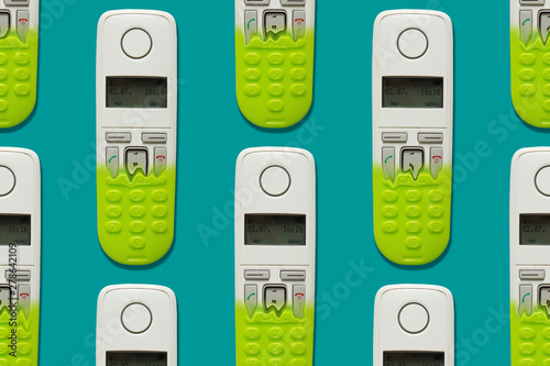 Pattern image of DECT phones turning into a toy phones on blue background. The concept of technology obsolescence. photo