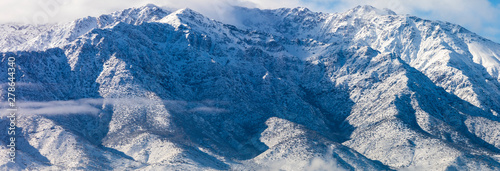 Cerro Ramon and Cerro La Cruz summits during a winter day. Snowcapped summits at central Andes mountains and amazing snowy rugged landscape on a cloudy day, an awe outdoor winter background scenery
 photo