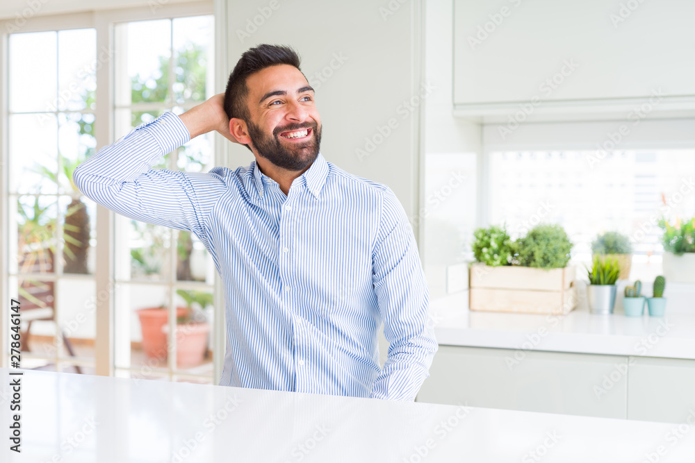 Handsome hispanic business man Smiling confident touching hair with hand up gesture, posing attractive