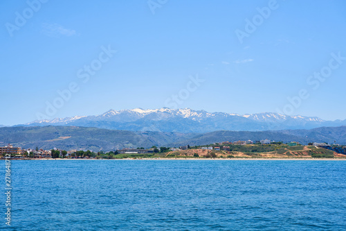 Sea coast of Chania, Crete, Greece with mountains and clear blue sky on a background.