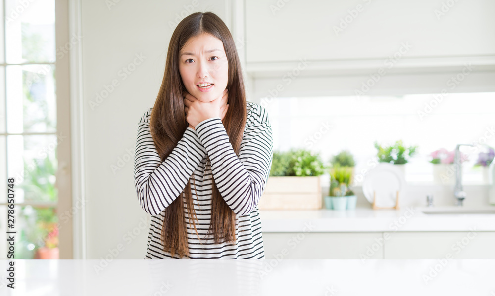 Beautiful Asian woman wearing stripes sweater shouting and suffocate because painful strangle. Health problem. Asphyxiate and suicide concept. Beautiful Asian woman wearing stripes sweater shouting and suffocate because painful strangle. Health problem. Asphyxiate and suicide concept.