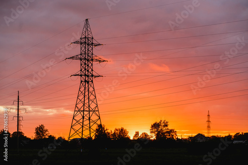 Pylon, high-voltage tower sky background. Beautiful colorful sunset.
