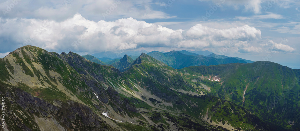 Panoramic view from Banikov peak on Western Tatra mountains or Rohace panorama. Sharp green mountains - ostry rohac, placlive and volovec with hiking trail on ridge. Summer blue sky white clouds. - obrazy, fototapety, plakaty 
