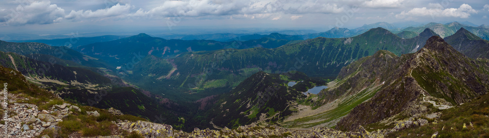Naklejka premium Panoramic view from Banikov peak on Western Tatra mountains or Rohace panorama. Sharp green mountains - ostry rohac, placlive and volovec with hiking trail on ridge. Summer blue sky white clouds.