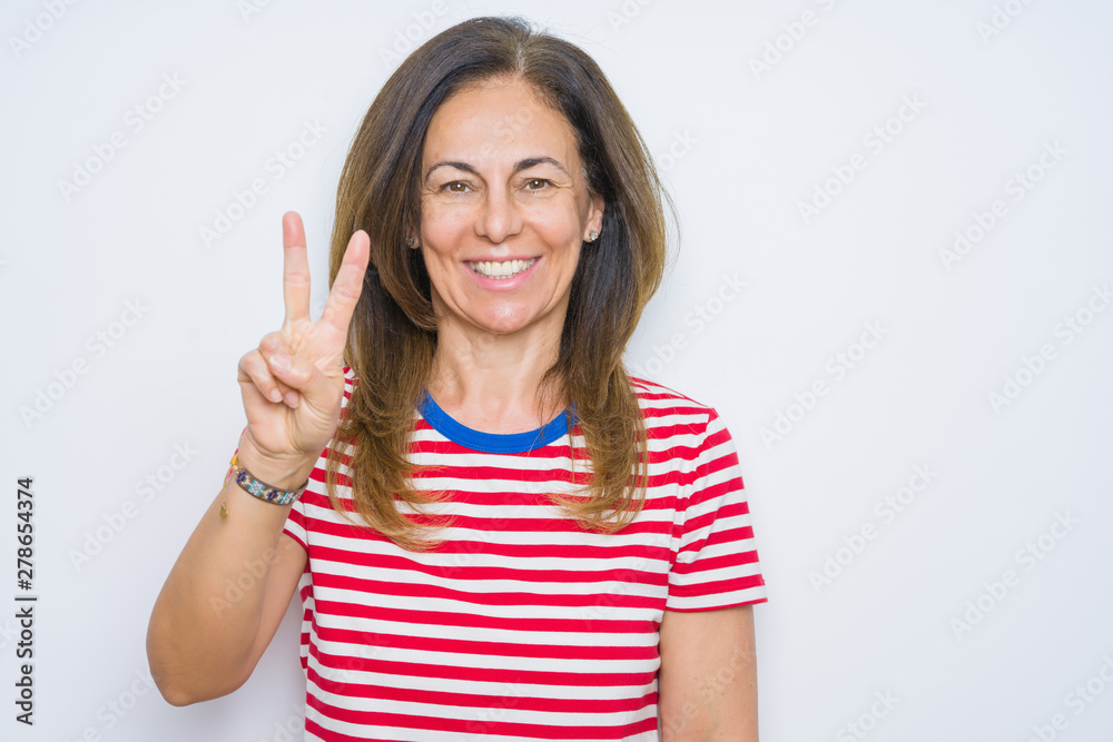 Middle age senior woman standing over white isolated background showing and pointing up with fingers number two while smiling confident and happy. Middle age senior woman standing over white isolated background showing and pointing up with fingers number two while smiling confident and happy.