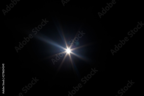 Fototapeta Naklejka Na Ścianę i Meble -  Lens Flare. Light over black background. Easy to add overlay or screen filter over photos. Abstract sun burst with digital lens flare background. Gleams rounded and hexagonal shapes, rainbow halo.