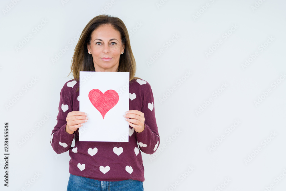 Middle age woman holding card gift with red heart over isolated background with a confident expression on smart face thinking serious Middle age woman holding card gift with red heart over isolated background with a confident expression on smart face thinking serious