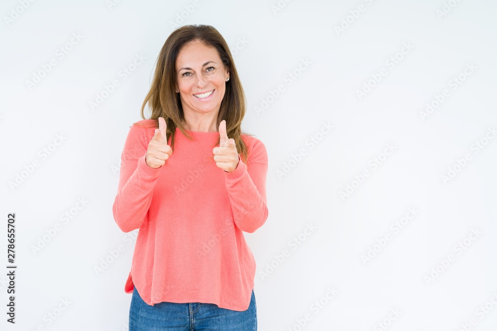 Beautiful middle age woman over isolated background pointing fingers to camera with happy and funny face. Good energy and vibes. Beautiful middle age woman over isolated background pointing fingers to camera with happy and funny face. Good energy and vibes.