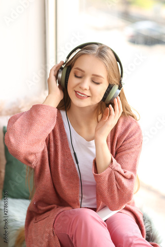 Beautiful young woman liste...