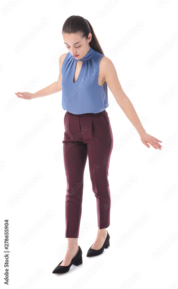 Balancing young businesswoman on white background