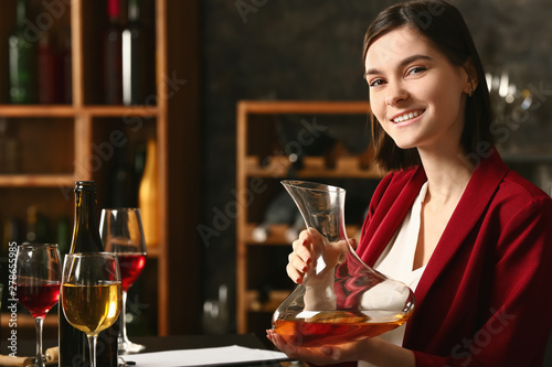 Young female sommelier work...