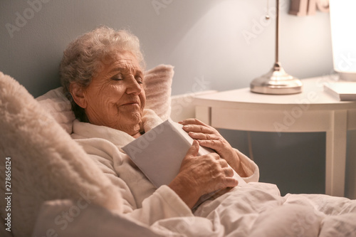 Senior woman with book slee...