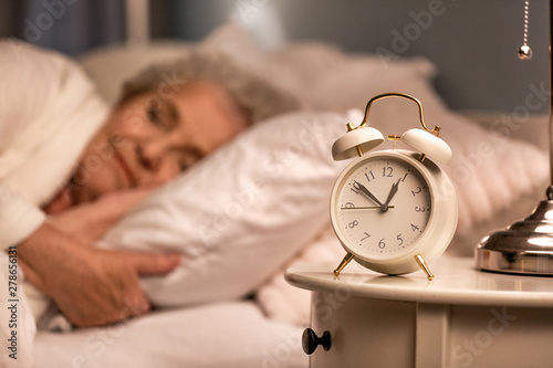 Alarm clock on table of sle...