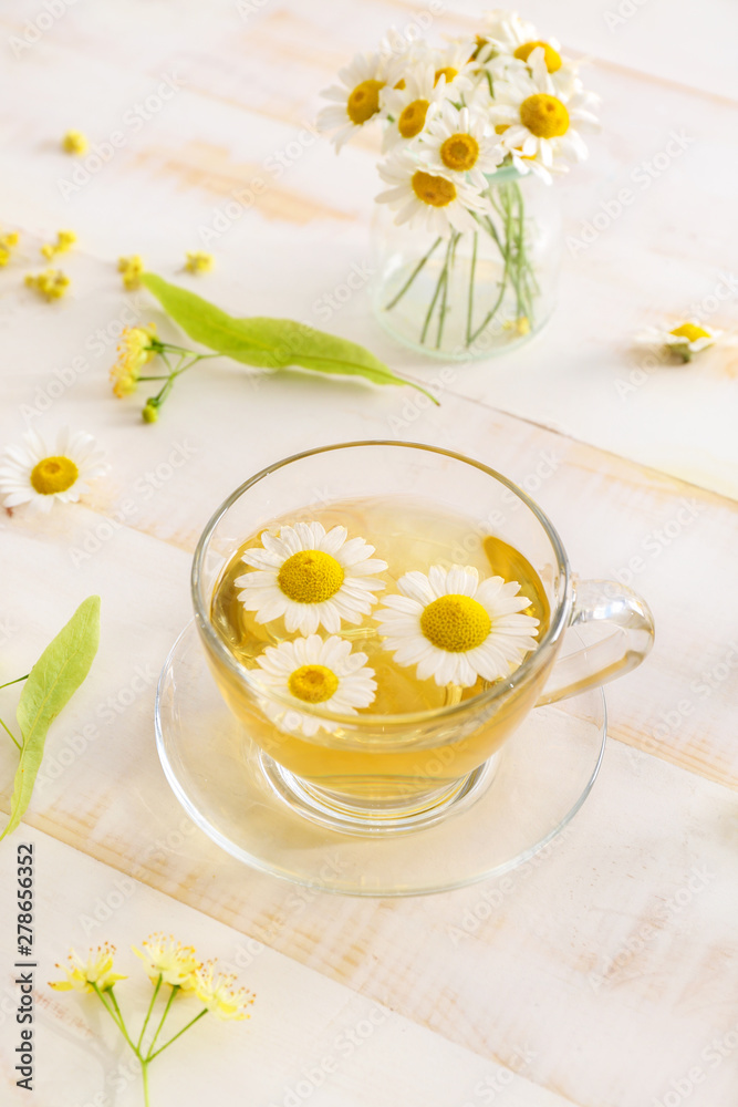 Cup of hot chamomile tea on wooden table Cup of hot chamomile tea on wooden table