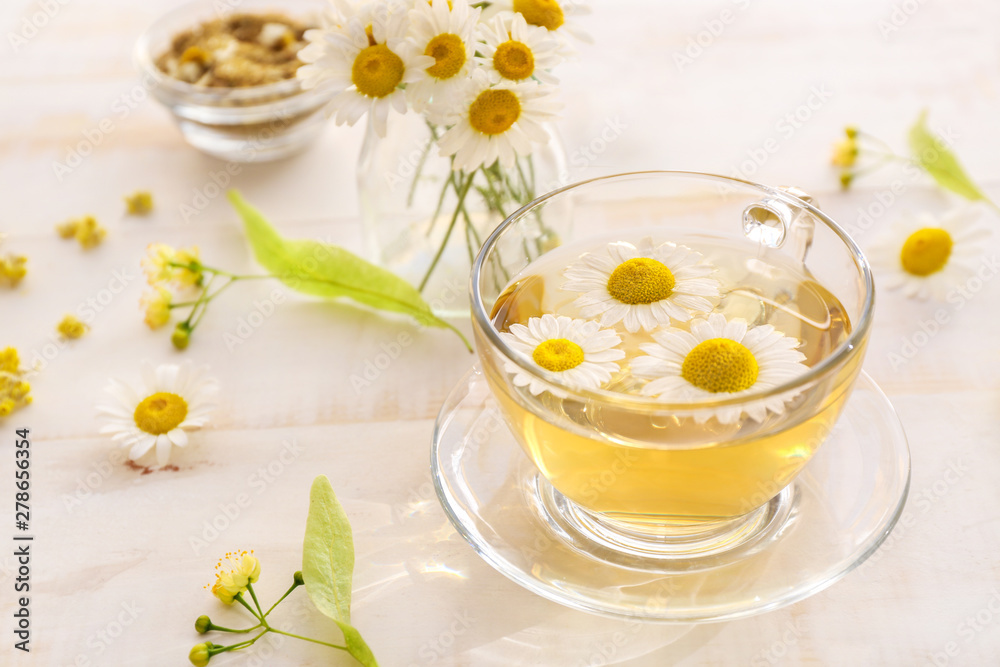 Cup of hot chamomile tea on wooden table Cup of hot chamomile tea on wooden table