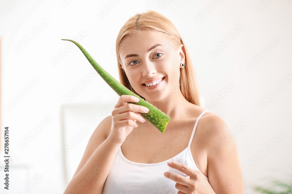 Beautiful young woman using cosmetics with aloe vera extract at home Beautiful young woman using cosmetics with aloe vera extract at home