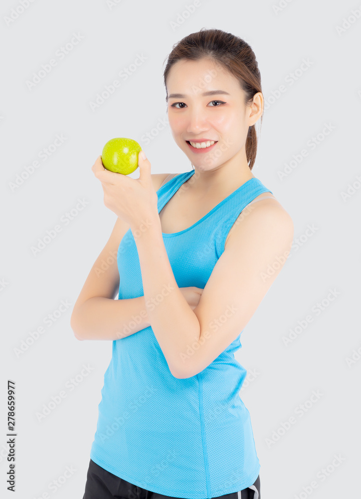 Beautiful portrait young asian woman in sport clothing with satisfied and holding green apple isolated on white background, girl asia have shape and wellness, exercise for fit with health concept. Beautiful portrait young asian woman in sport clothing with satisfied and holding green apple isolated on white background, girl asia have shape and wellness, exercise for fit with health concept.