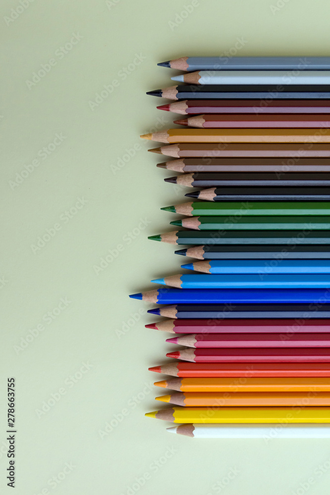 Fototapeta premium Color pencils on green background