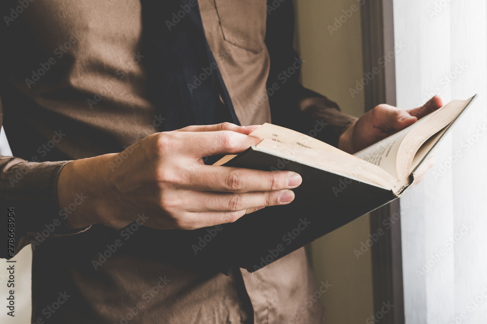 Businessman holding book at window. Creative Business Startup Idea.