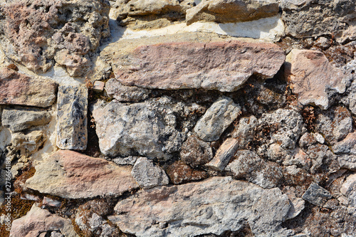 Masonry stone wall in the a...