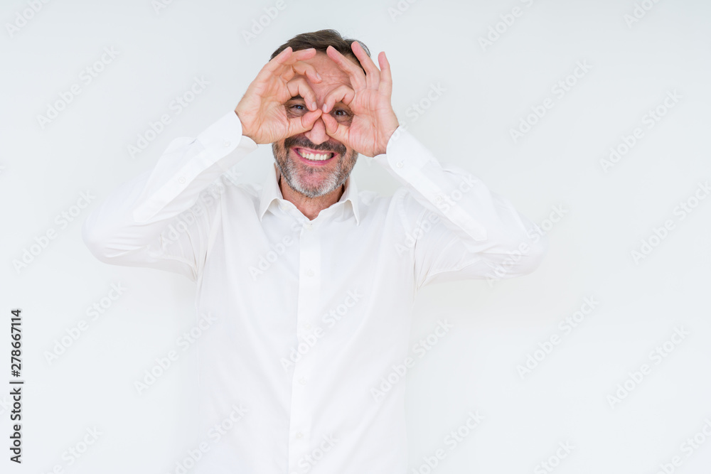 Elegant senior man over isolated background doing ok gesture like binoculars sticking tongue out, eyes looking through fingers. Crazy expression. Elegant senior man over isolated background doing ok gesture like binoculars sticking tongue out, eyes looking through fingers. Crazy expression.
