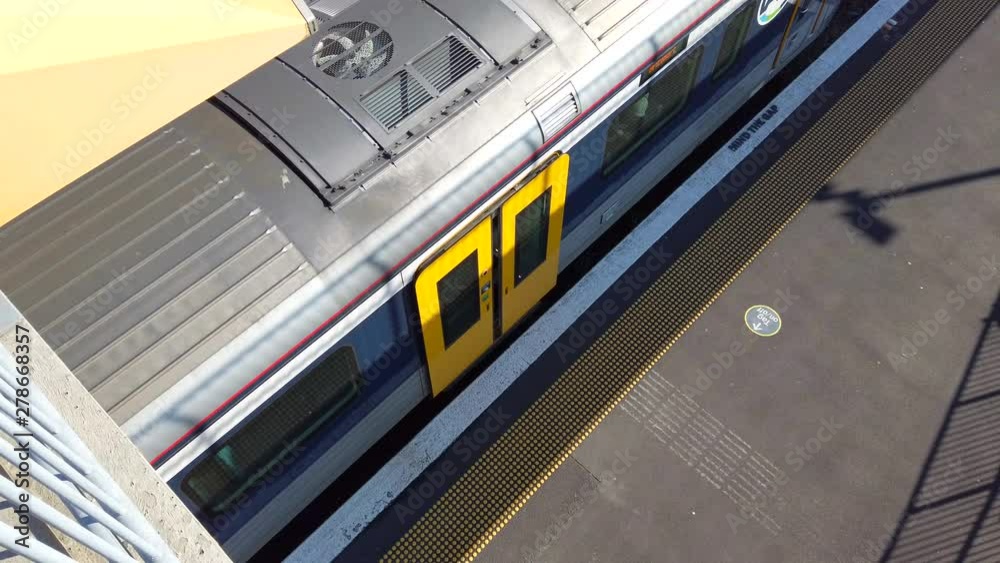Train door closes on electric multiple unit shot from above