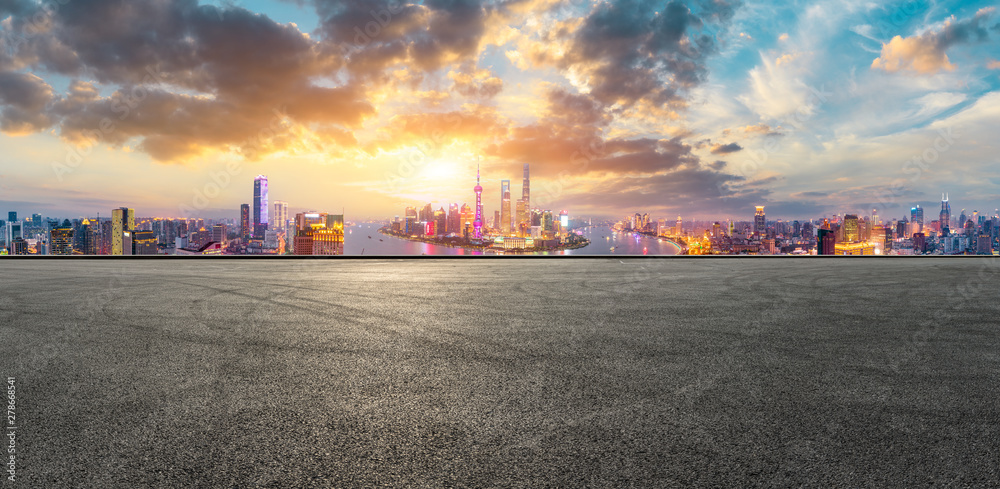 Empty race track and modern city skyline in Shanghai at sunset,China