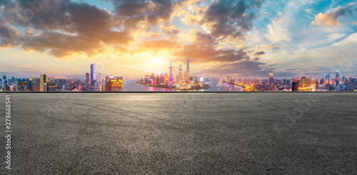 Empty race track and modern city skyline in Shanghai at sunset,China