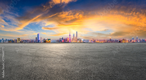 Empty race track and modern city skyline in Shanghai at sunset,China