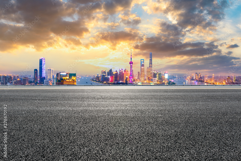 Empty asphalt highway and modern city skyline in Shanghai at sunset,China