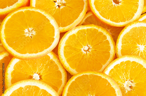 Slices of ripe orange fruits as background