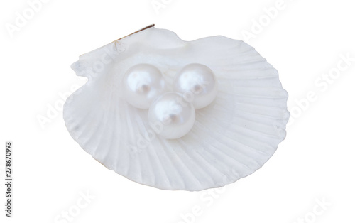 White pearls in scallop seashell isolated on white