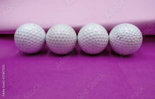 Golf ball on pink background
