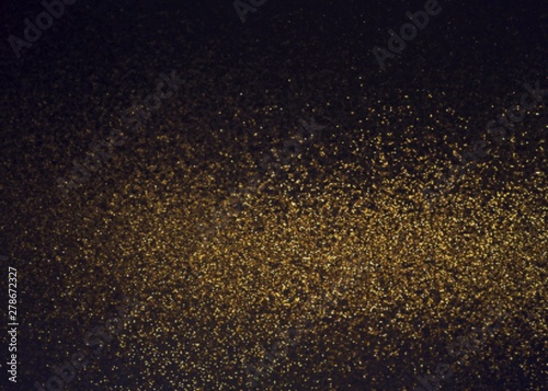 Shimmer golden dust cloud abstract pattern on black background.