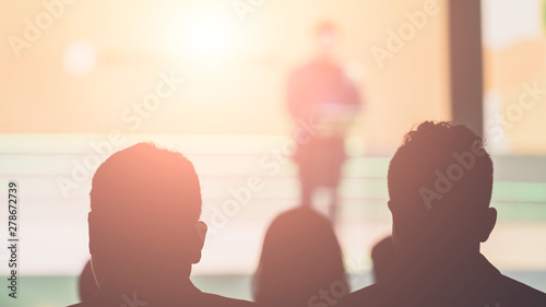 Disfocus of the Speaker on stage and giving talk at business meeting. Audience in the conference hall. Business and Entrepreneurship. photo