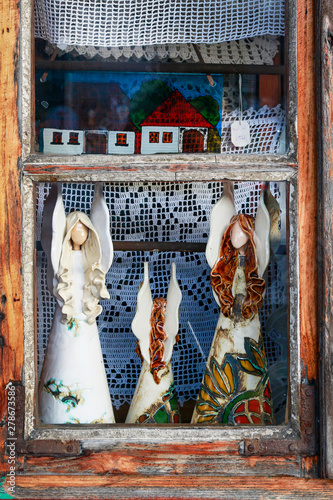 LANCKORONA, POLAND - APRIL 08,2018: Ceramic angels set in the window in historic city centre of Lanckorona, polish resort photo